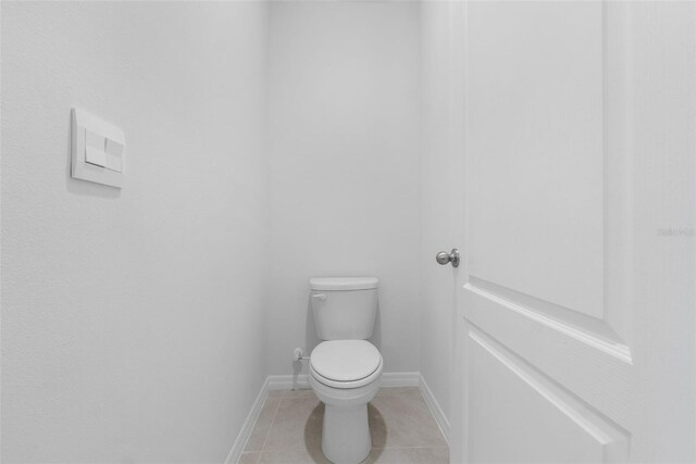 bathroom with toilet and tile patterned floors