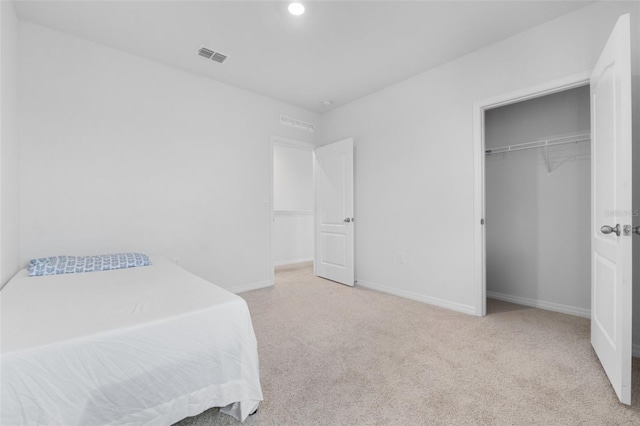 carpeted bedroom with a closet