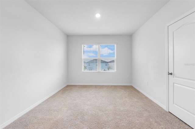 empty room featuring light colored carpet