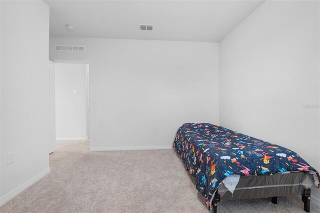 bedroom featuring light carpet