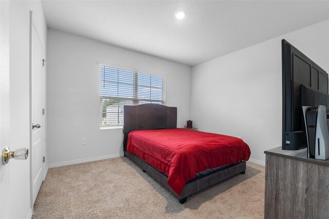 bedroom with light colored carpet