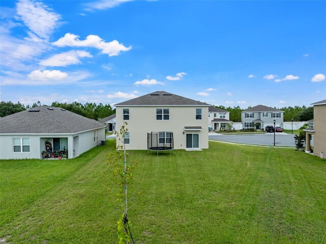 rear view of property featuring a yard