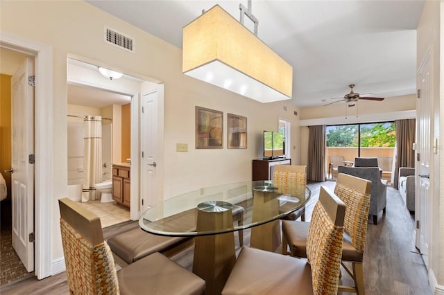 dining area with light hardwood / wood-style flooring and ceiling fan