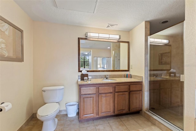 bathroom featuring an enclosed shower, tile patterned floors, toilet, vanity, and a textured ceiling