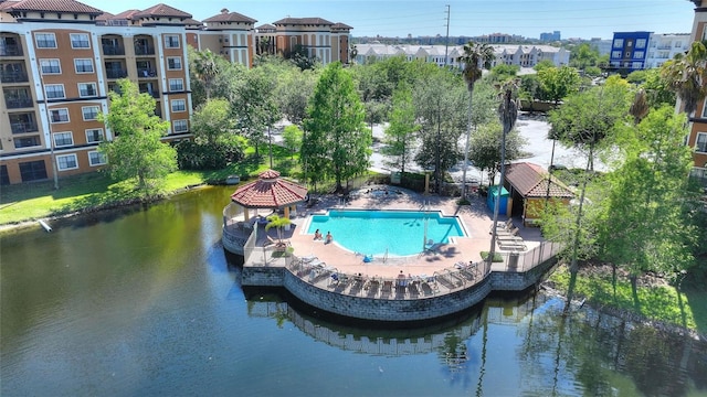 view of pool with a water view, a patio area, and a gazebo