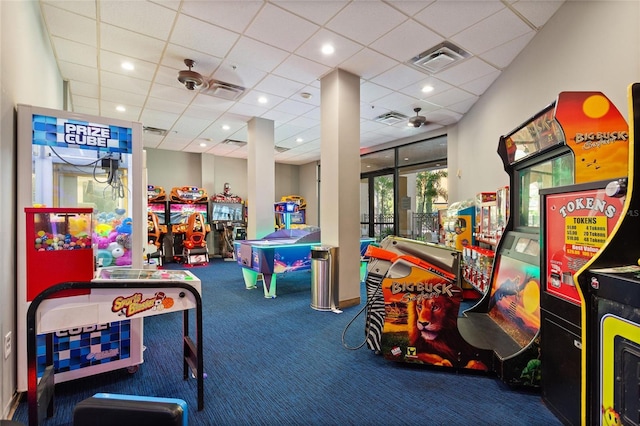 rec room with a paneled ceiling, ceiling fan, and carpet floors