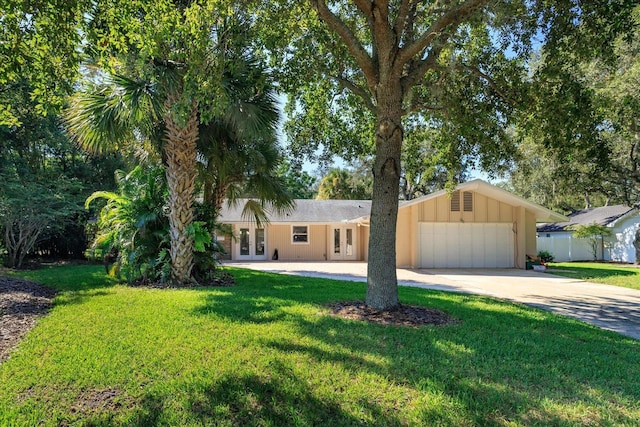 ranch-style house with a garage and a front yard