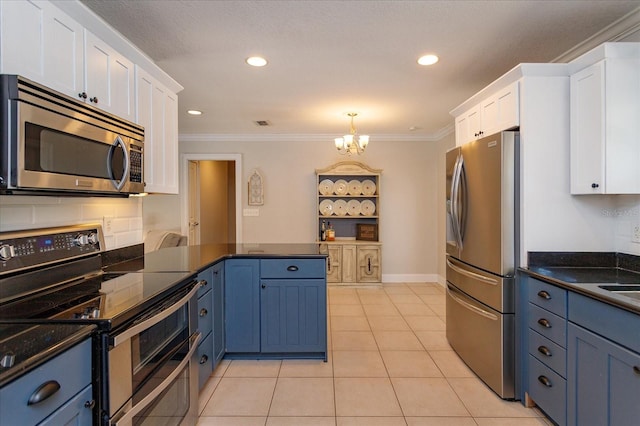 kitchen featuring an inviting chandelier, stainless steel appliances, white cabinetry, and blue cabinetry