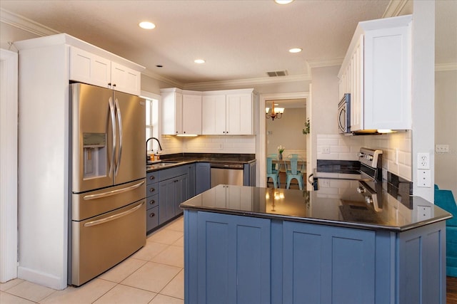 kitchen featuring white cabinets, appliances with stainless steel finishes, a chandelier, and kitchen peninsula