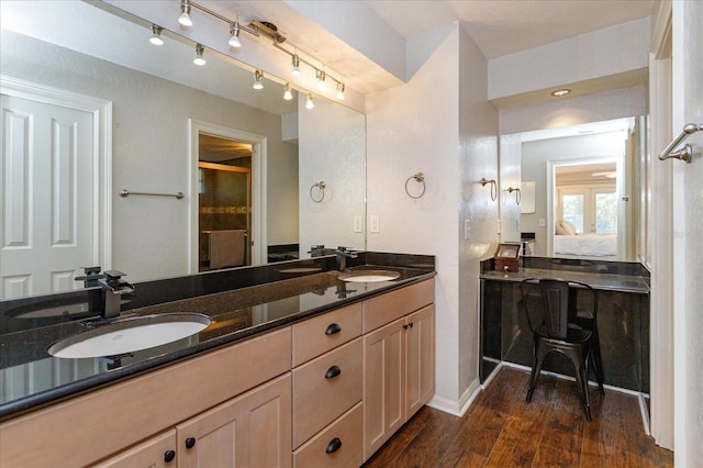 bathroom with vanity, a shower with door, and hardwood / wood-style floors