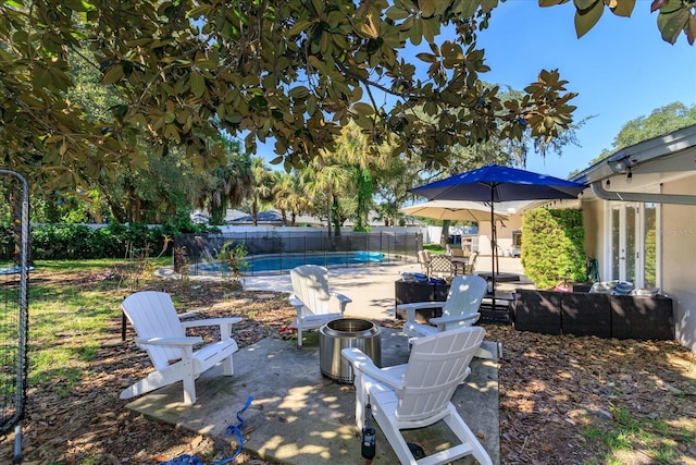 view of patio / terrace with a fenced in pool