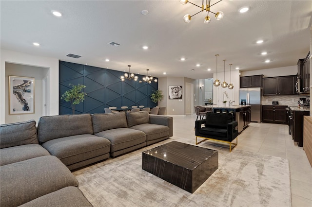 living room with light tile patterned flooring and an inviting chandelier