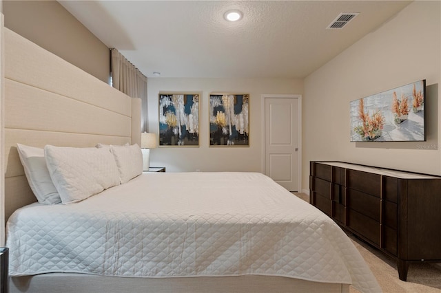 carpeted bedroom featuring a textured ceiling