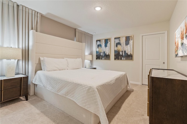 bedroom with light colored carpet