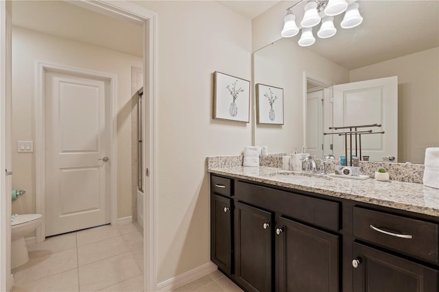 bathroom featuring a notable chandelier, vanity, toilet, and tile patterned floors