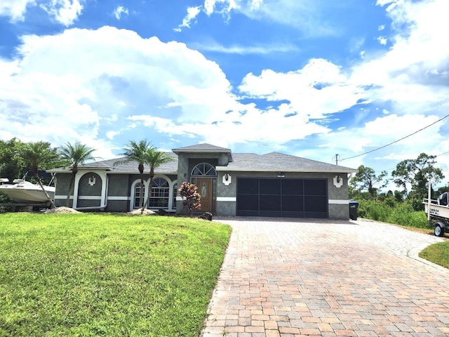 view of front of house with stucco siding, an attached garage, decorative driveway, and a front yard