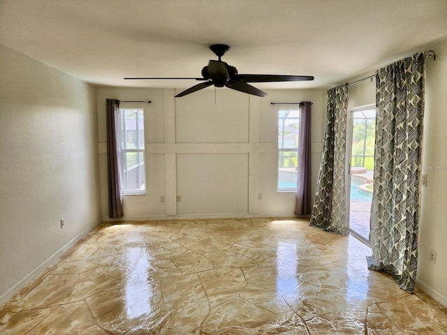 unfurnished room with baseboards, marble finish floor, and ceiling fan