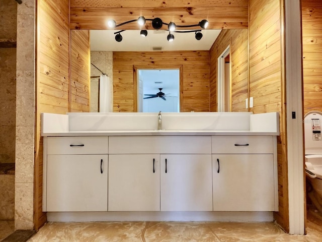 full bathroom with vanity, a shower with shower curtain, visible vents, wood walls, and toilet