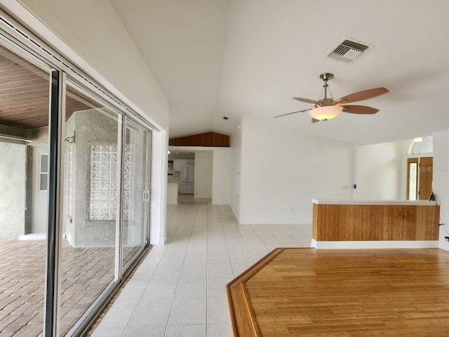 interior space with visible vents, ceiling fan, light wood-type flooring, and lofted ceiling