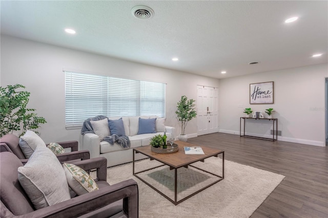 living room with dark hardwood / wood-style flooring