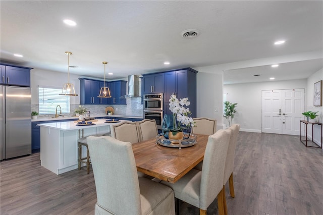 dining room with hardwood / wood-style flooring and sink