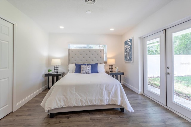 bedroom with dark wood-type flooring, access to exterior, and french doors