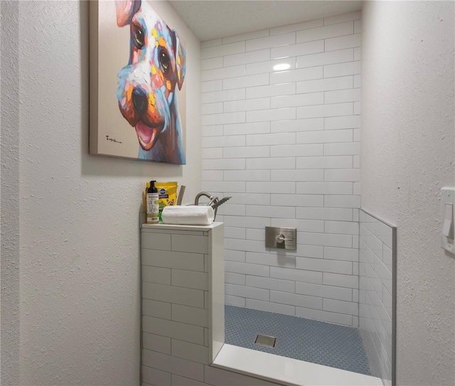 bathroom with tiled shower