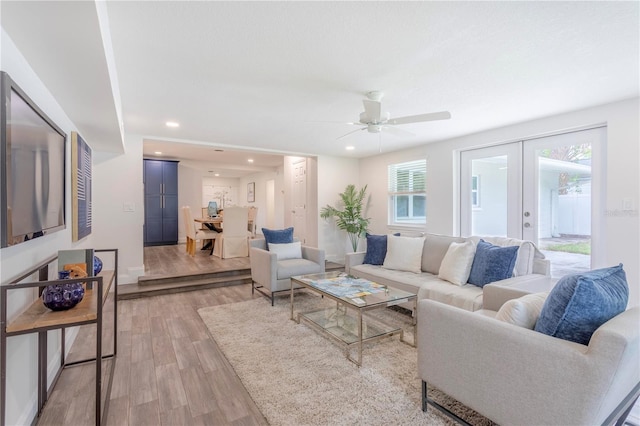 living room with french doors, light hardwood / wood-style floors, and ceiling fan