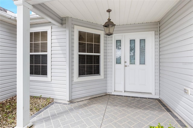 entrance to property featuring a patio