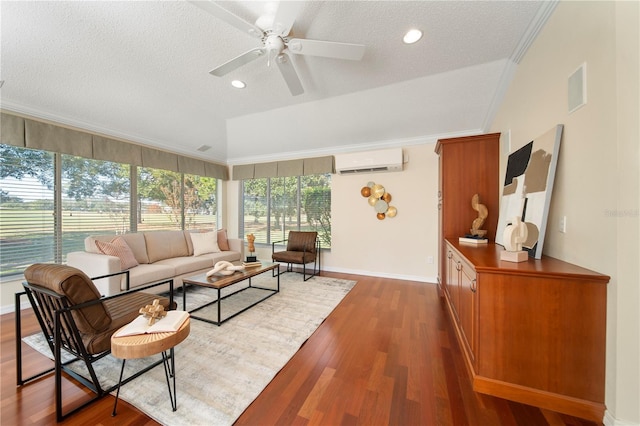 living room featuring ornamental molding, a textured ceiling, a wall mounted AC, ceiling fan, and dark hardwood / wood-style floors