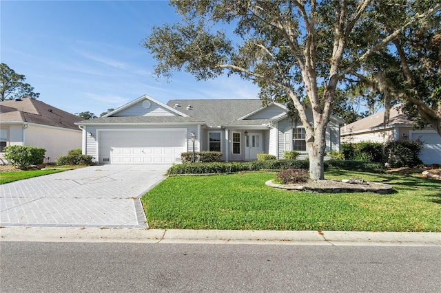 ranch-style house with a garage and a front lawn