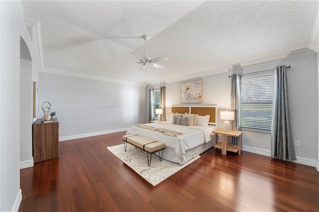 bedroom with multiple windows, dark hardwood / wood-style flooring, ceiling fan, and ornamental molding