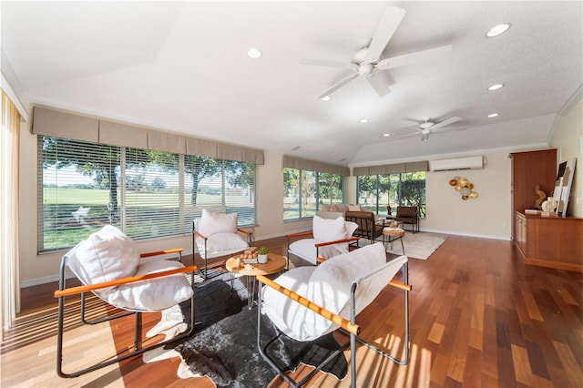 living room with lofted ceiling, ceiling fan, ornamental molding, a wall mounted AC, and wood-type flooring