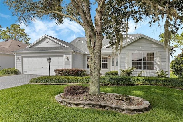 ranch-style home featuring a front lawn and a garage