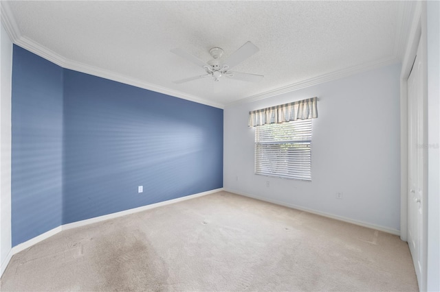 unfurnished room featuring a textured ceiling, light colored carpet, ceiling fan, and crown molding