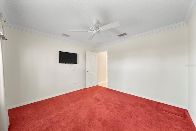 carpeted spare room with ceiling fan, ornamental molding, and a textured ceiling