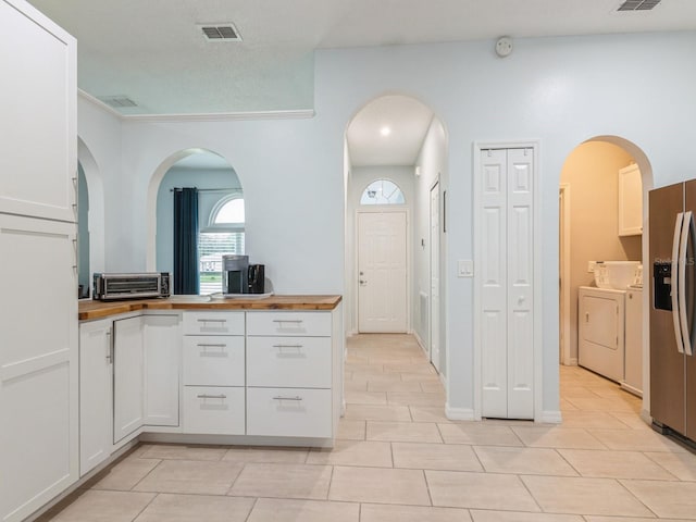 bathroom featuring tile patterned floors and washer and dryer