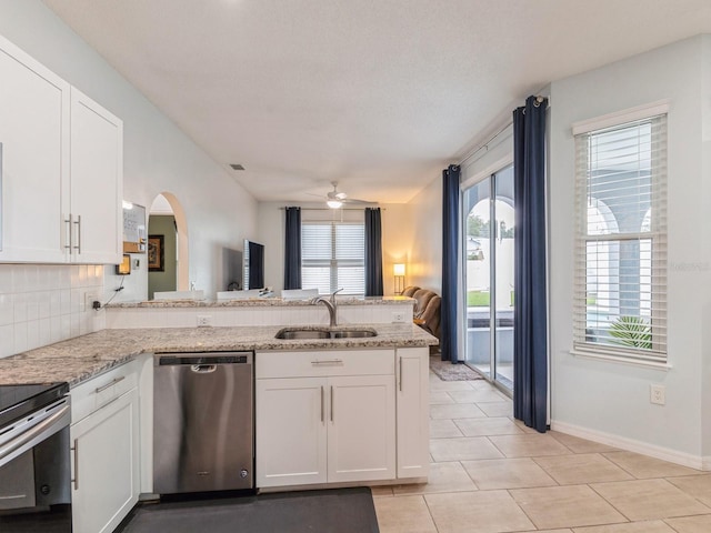 kitchen featuring dishwasher, ceiling fan, sink, and kitchen peninsula