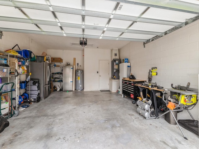 garage featuring stainless steel refrigerator, electric water heater, and a garage door opener