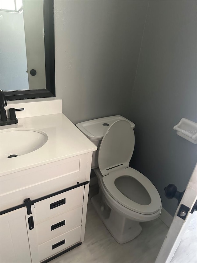 bathroom featuring toilet and vanity