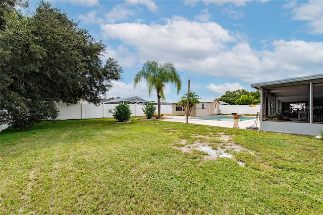 view of yard featuring a fenced in pool and a sunroom