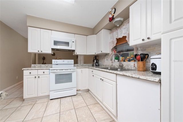 kitchen featuring backsplash, white appliances, light stone counters, white cabinetry, and sink