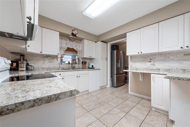 kitchen featuring stainless steel appliances, sink, backsplash, and white cabinetry