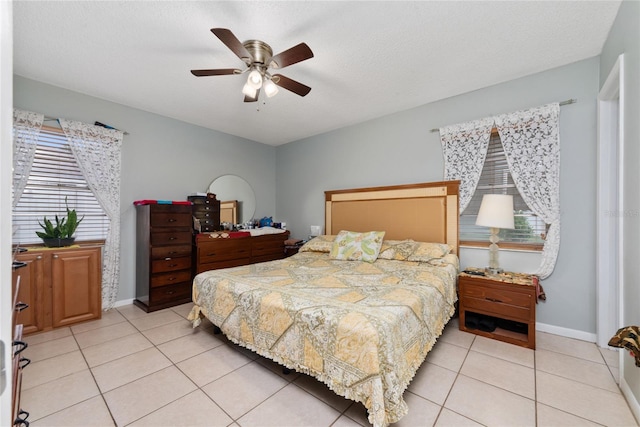 tiled bedroom with a textured ceiling and ceiling fan