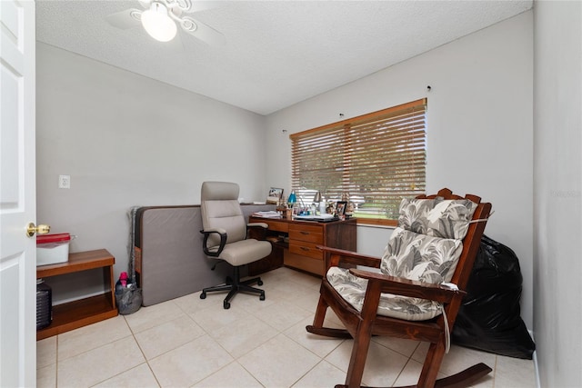 office with a textured ceiling, ceiling fan, and light tile patterned flooring