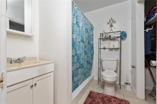 bathroom featuring tile patterned flooring, vanity, toilet, and curtained shower