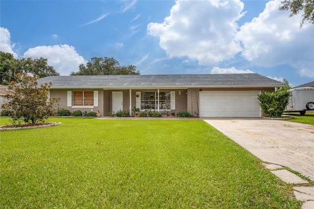 ranch-style house featuring a front yard and a garage