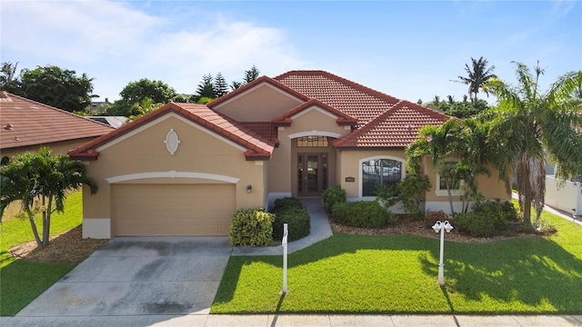 mediterranean / spanish-style house with a front yard and a garage