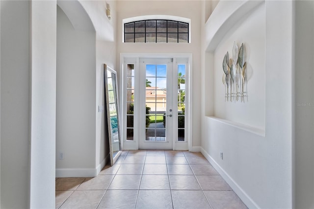 foyer entrance featuring a healthy amount of sunlight and light tile patterned floors