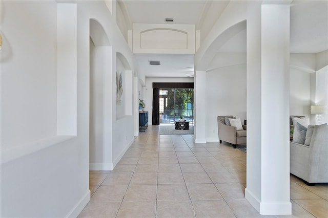 hall with light tile patterned floors